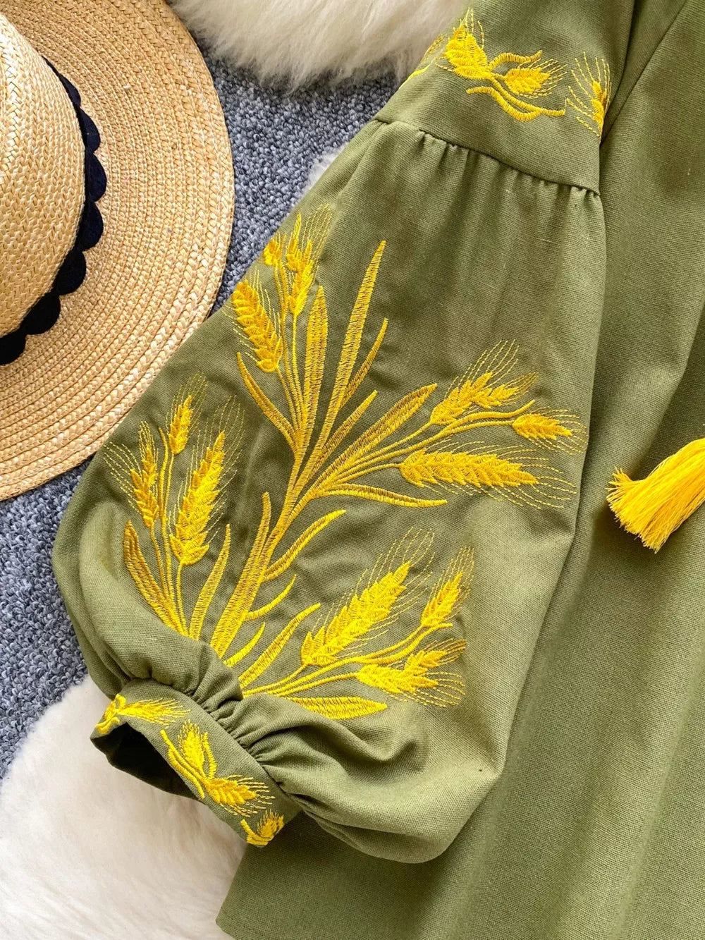 Green embroidered tie-neck blouse with balloon sleeves and yellow wheat detail.