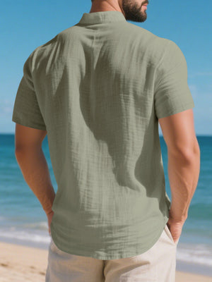 Men's military green cotton band collar short-sleeve shirt with textured fabric detail.