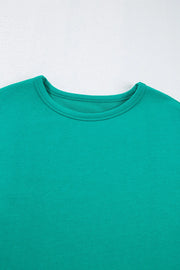 Turquoise crewneck sweatshirt with relaxed fit and crew neckline.