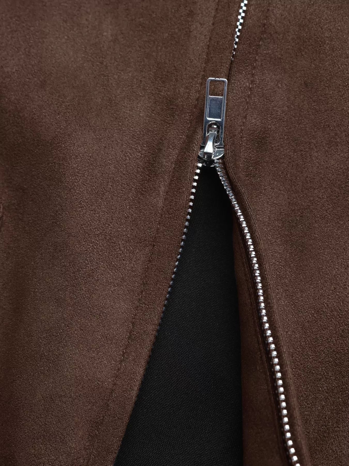 Brown zip-up jacket detail showing silver zipper and suede-like texture.