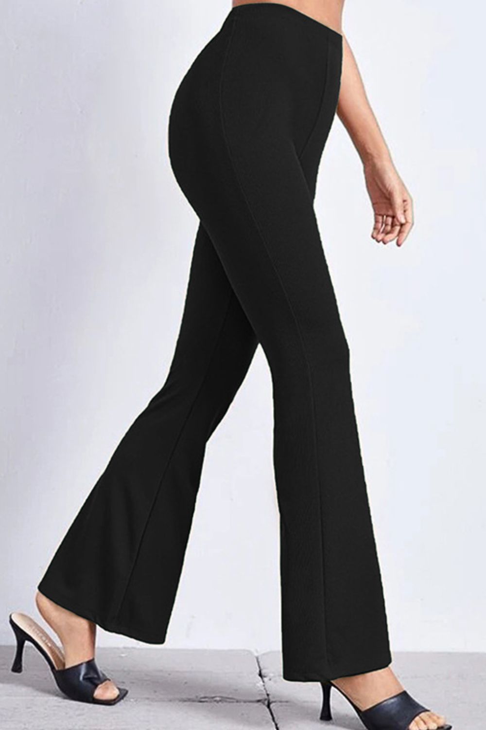 Black textured flare leggings with a subtle ribbed pattern, shown on a model.