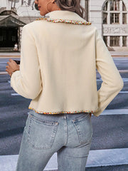 Cream bolero jacket with floral trim on collar and hem, buttoned front.