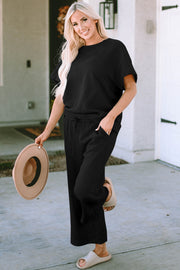 Black textured knit tee and wide leg pants set with drawstring waist and pockets.