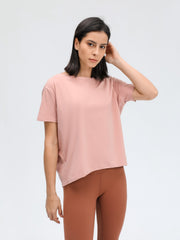 Relaxed fit performance tee in dusty rose with short sleeves and a boat neck.