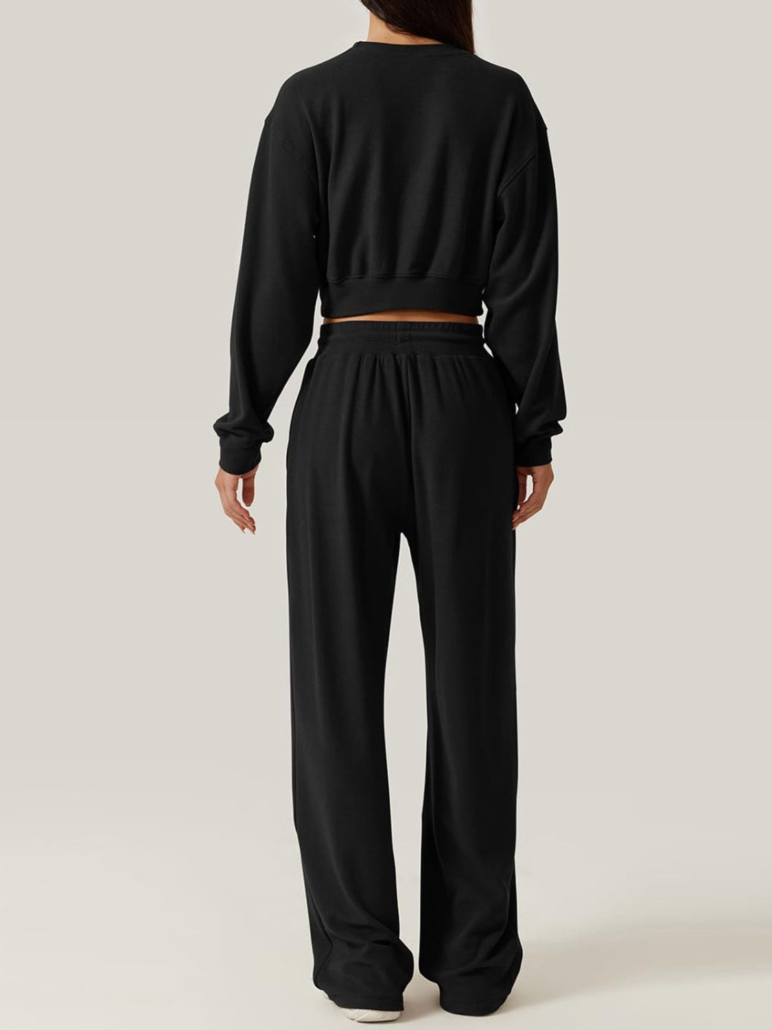 Black knit lounge set with cropped sweatshirt and wide-leg pants
