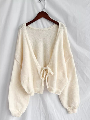 Cream textured tie-front knit cardigan with balloon sleeves and a relaxed fit.