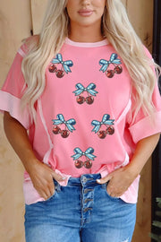 Pink polyester t-shirt with sequin cherry and bow graphic print