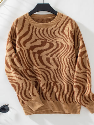 Camel wavy knit crewneck sweater with brown abstract pattern.