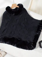 Black cable knit poncho with faux fur trim and collar detail.