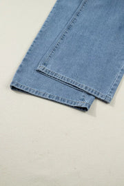Retro pleated wide-leg denim jumpsuit in light blue, showing hem detail