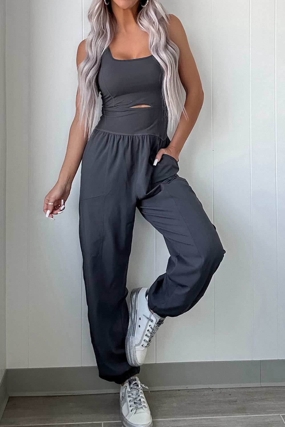 Dark gray jumpsuit with cutout bodice and gathered legs, elastic waist, and pockets.
