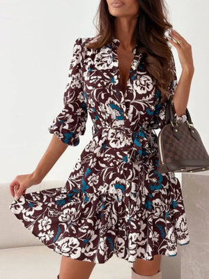 Brown floral tie-waist mini dress with button-down front and tiered skirt.