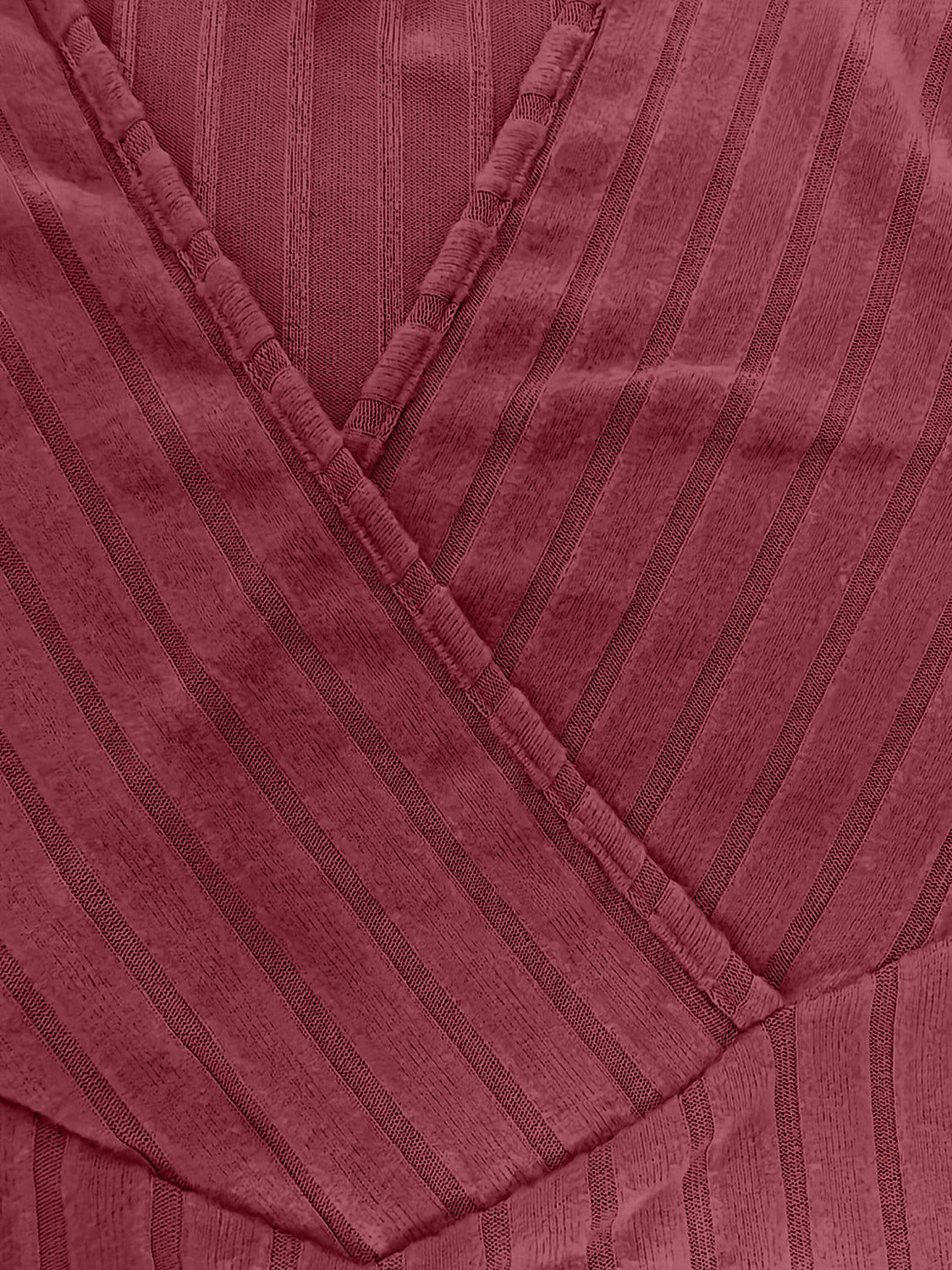 Plunging ribbed wrap top in rust with vertical stripe texture and crossover detail.