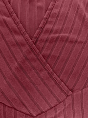 Plunging ribbed wrap top in rust with vertical stripe texture and crossover detail.