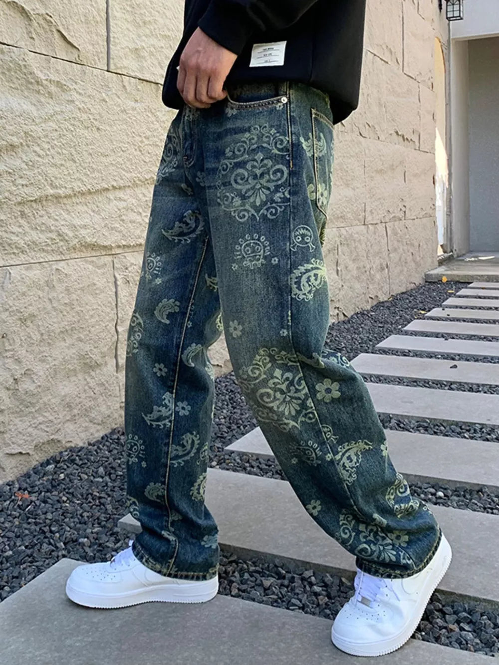 Men's heritage-inspired floral print denim jeans with a vintage wash.