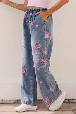 Floral wide-leg jeans with elastic waistband and pink floral print on denim.