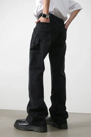 Dark wash denim wide leg carpenter jeans with utility pockets.