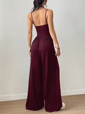 Burgundy ruched wide-leg jumpsuit with spaghetti straps and a cinched waist.