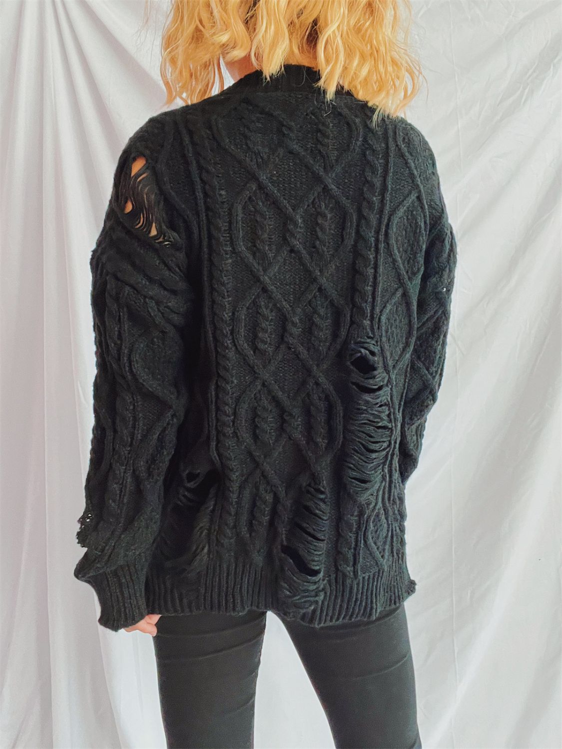 Black distressed cable knit sweater with ripped details