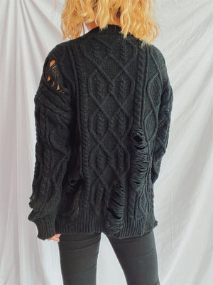 Black distressed cable knit sweater with ripped details