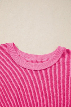 Pink ribbed maternity t-shirt with crew neck and textured vertical stripes.