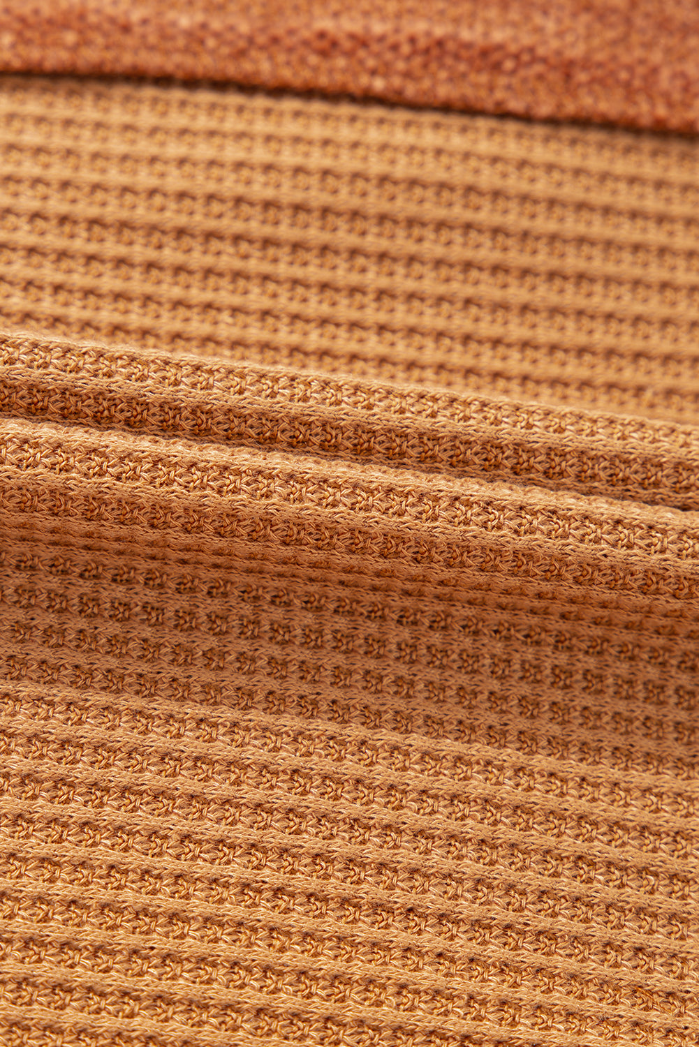 Caramel waffle knit henley top with contrast stitching detail.
