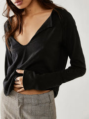 Black long sleeve tee with distressed slouchy plunge neckline and raw edge detail.