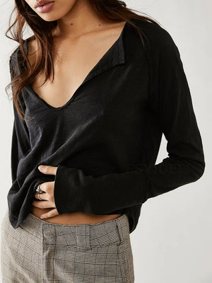 Black long sleeve tee with distressed slouchy plunge neckline and raw edge detail.