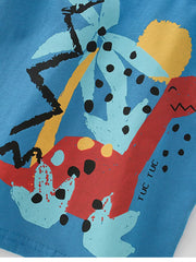 Toddler graphic tee in blue with a red dinosaur, palm trees, and abstract shapes.