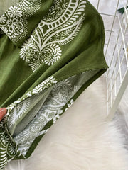 Green wide leg romper with white paisley print and button detail.