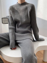 Asymmetric ribbed knit co-ord set in dark gray, featuring a mock neck sweater and wide-leg pants.