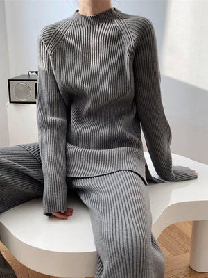 Asymmetric ribbed knit co-ord set in dark gray, featuring a mock neck sweater and wide-leg pants.