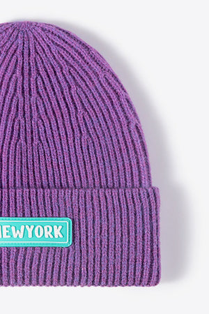 Purple ribbed acrylic beanie with New York patch detail