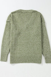 Open-knit slouchy V-neck sweater in matcha green with a textured pattern and ribbed cuffs and hem.