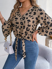 Khaki leopard print tie-front blouse with button detail and bell sleeves.