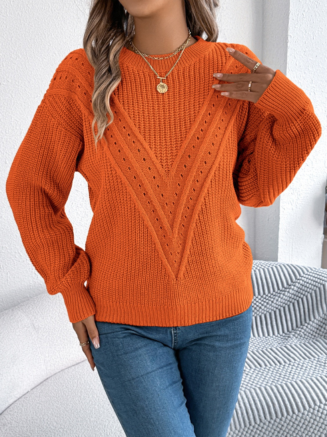 Orange chevron knit detail sweater with crewneck and long sleeves.
