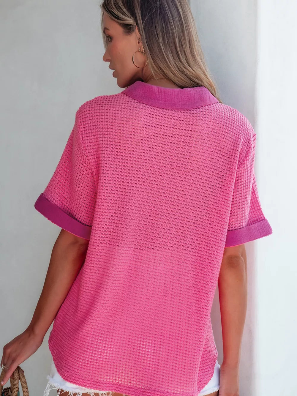Pink waffle-knit button-down shirt with short sleeves and contrast collar and cuffs.