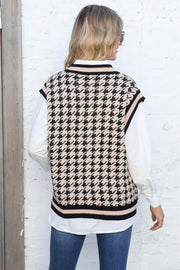 Houndstooth knit vest in apricot with black trim, V-neck, sleeveless, acrylic.
