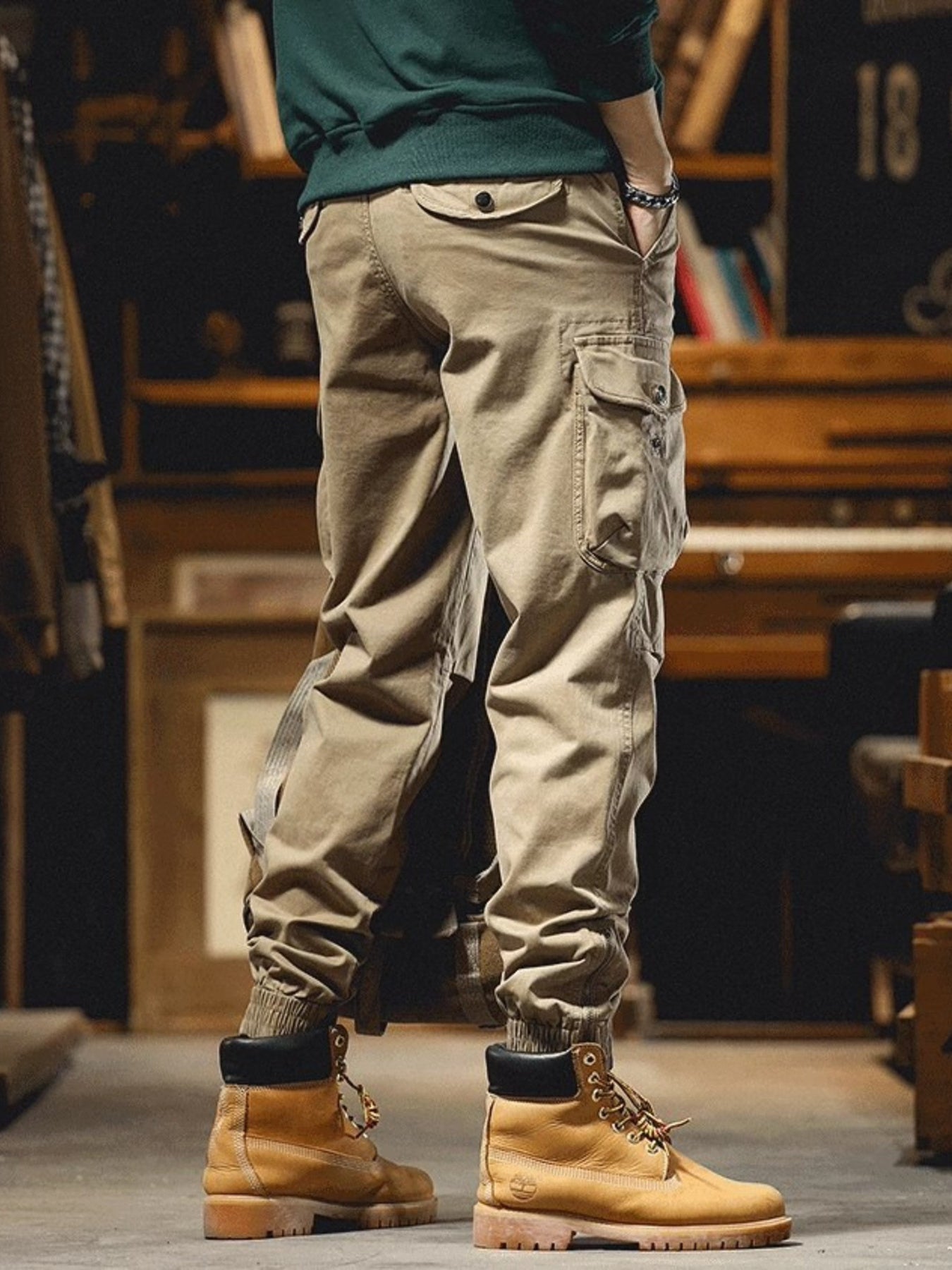 Men's khaki cargo joggers with drawstring and multiple pockets.