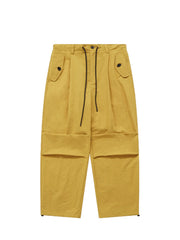 Ginger yellow cargo joggers with drawstring waist and button flap pockets.