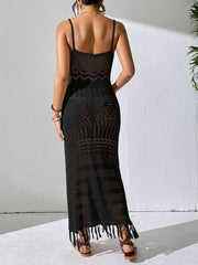 Black crochet maxi dress with spaghetti straps and a fringe hem.