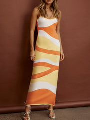 Geometric knit maxi slip dress in orange, yellow, and white wavy stripes.