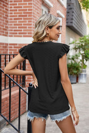 Black lace trimmed flutter sleeve blouse with eyelet detail and scalloped neckline.