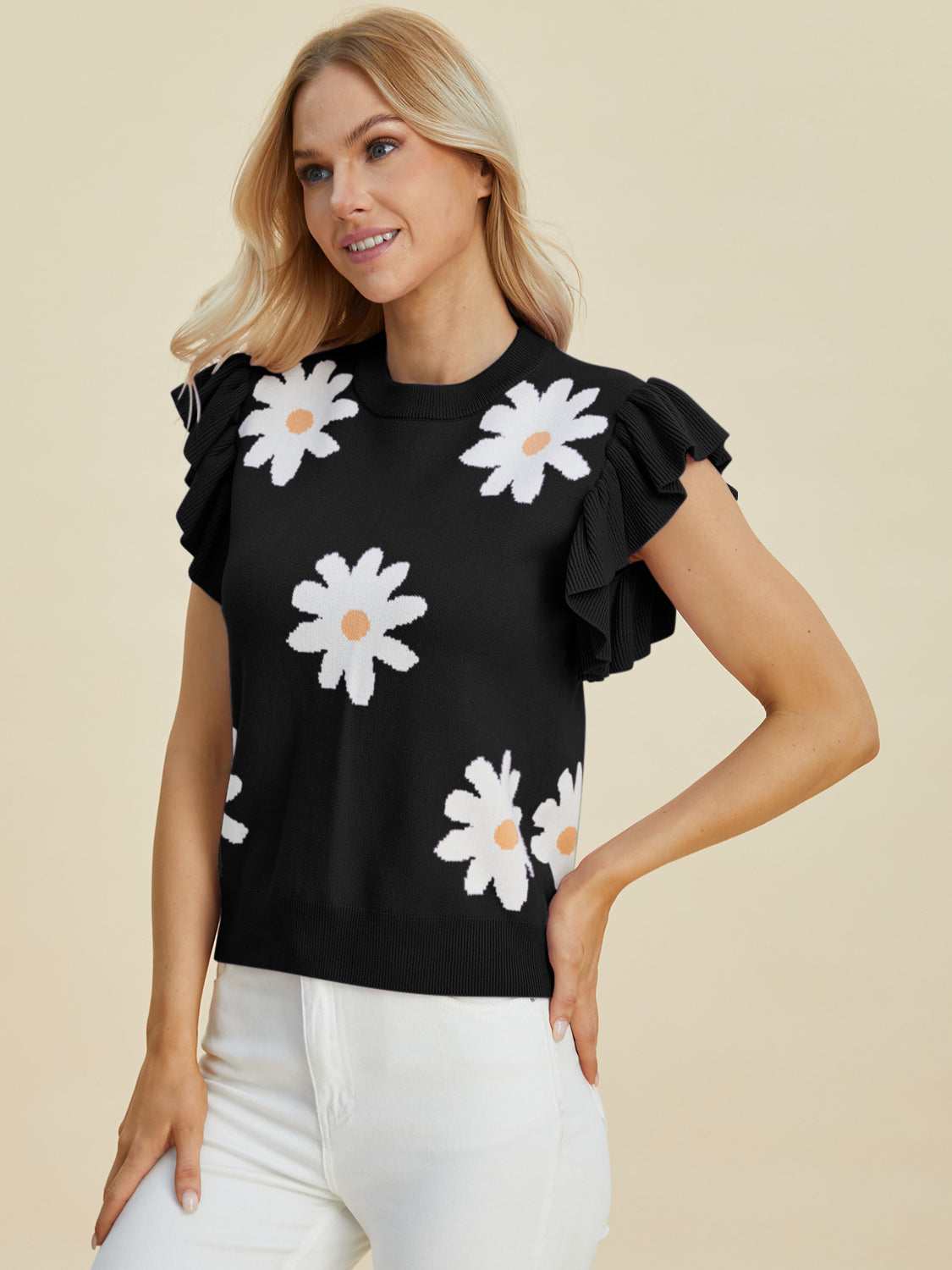 Black knit blouse with white daisy print and ruffled short sleeves