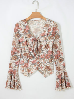 Charming floral print tie-neck blouse with bell sleeves.