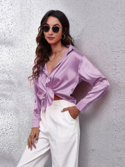 Lilac satin button-down shirt with knot detail and long sleeves.