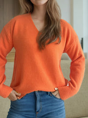 Orange V-neck knit sweater with ribbed hem and cuffs, relaxed fit.