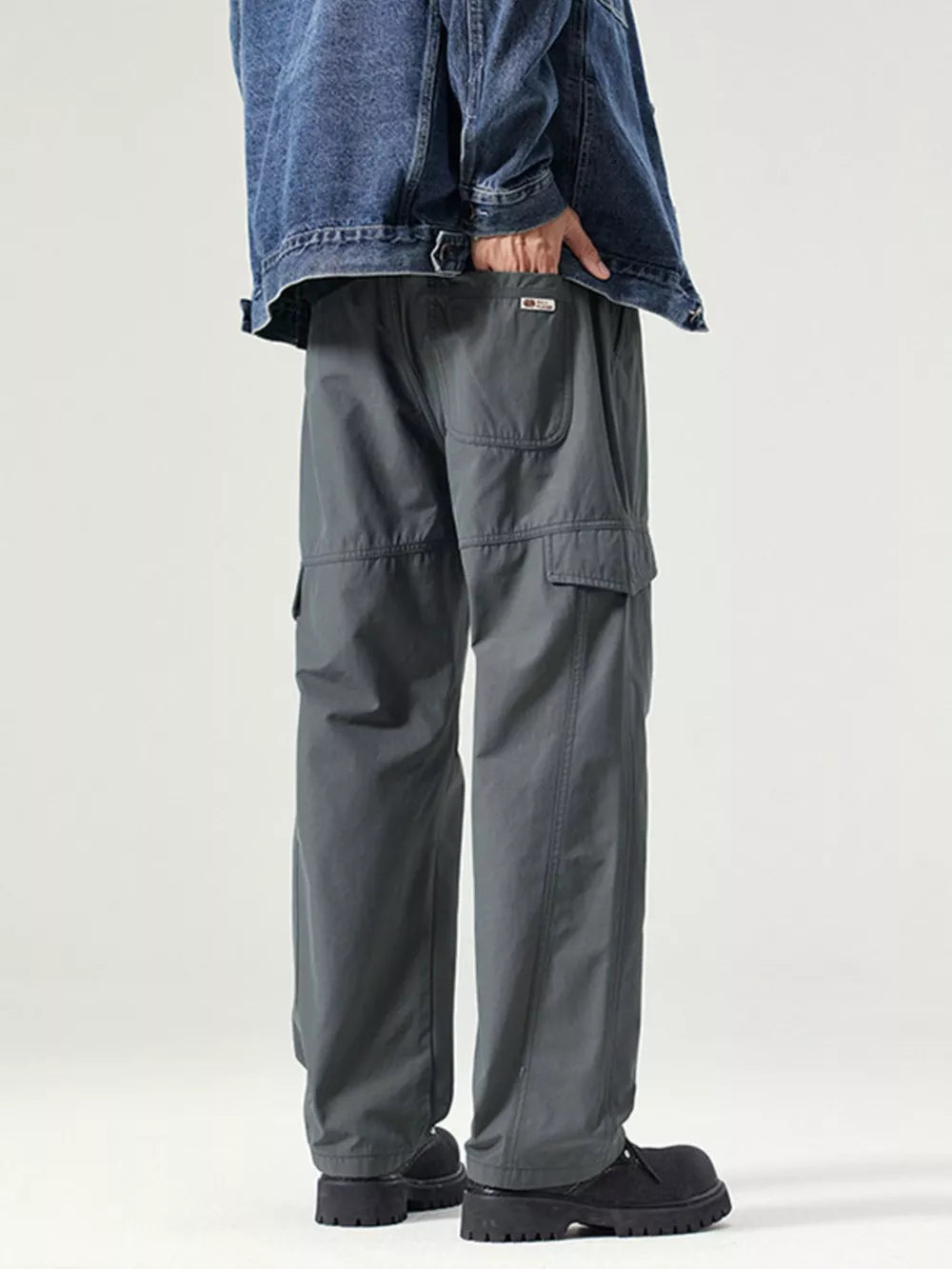 Dark gray utility cargo pants with adjustable waist and multiple pockets.