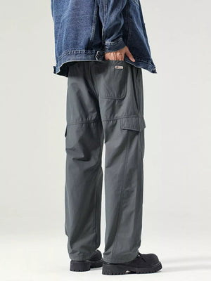 Dark gray utility cargo pants with adjustable waist and multiple pockets.