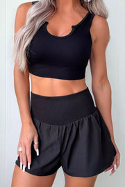 Black athletic jogger shorts with a ribbed high waistband and a flowy fit.